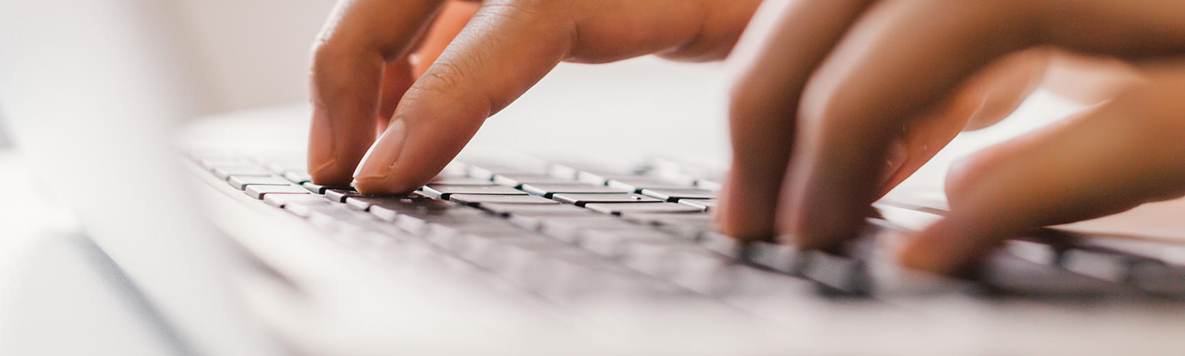 Close up of hands typing on laptop