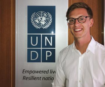 Chris Zabilowicz standing in front of the UNDP logo