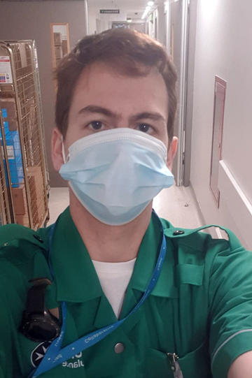 JP Ay selfie in scrubs with mask on