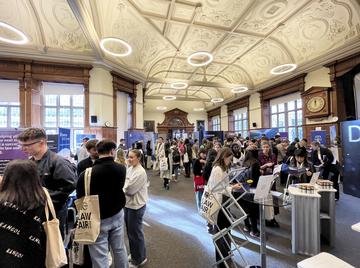Students and employer stands at a Careers Service fair in the Examination Schools