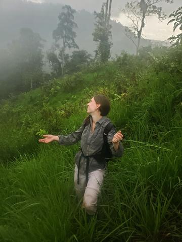 Oxford student Ruth Arnold on trekking through the rainforest. This is a picture taken after a day of setting camera traps in the field, and it started pouring with rain. 