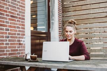 Student on laptop in back garden